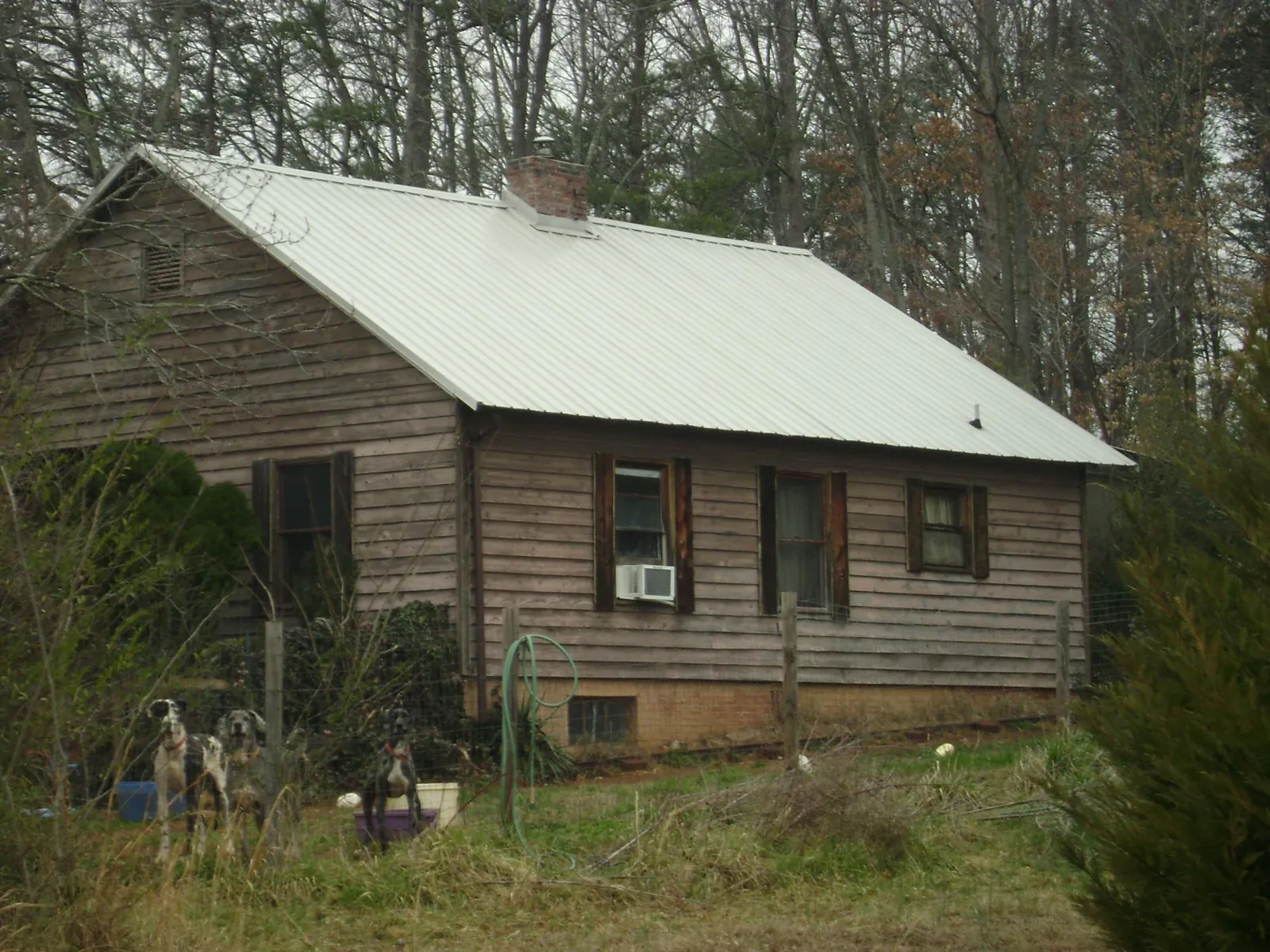 White metal roof on an old wood sided farmhouse, from a Metal Roof Installation job in Churchville